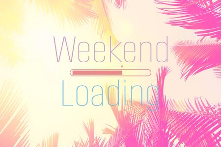 Weekend loading words on tropical palm tree background. Summer vacation and travel holiday concept. Vintage tone filter effect color style.の写真素材