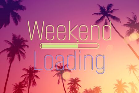 Weekend loading words on tropical palm tree background. Summer vacation and travel holiday concept. Vintage tone filter effect color style.の写真素材