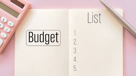 Notebook calculator and pen with budget list words on pastel color background.の写真素材