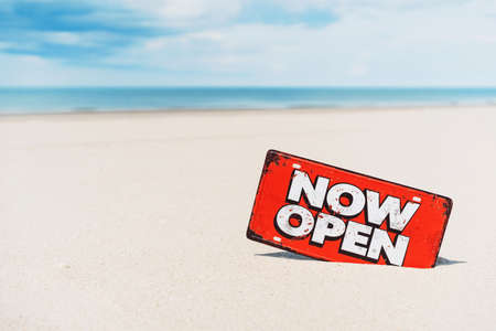 Open sign on tropical sand beach with blue sky background. Summer vacation and travel holiday concept. Vintage tone fitler effect color style.の写真素材