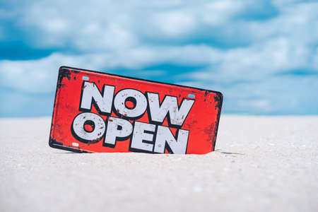 Open sign on tropical sand beach with blue sky background. Summer vacation and travel holiday concept. Vintage tone fitler effect color style.の写真素材