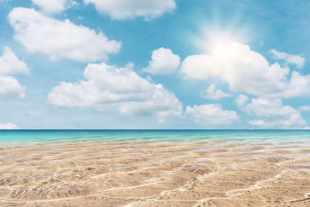 Copy space blur tropical beach with bokeh sun light wave on blue sky and white cloud abstract background. Summer vacation outdoor and travel holiday adventure concept. Vintage tone filter effect color.の写真素材