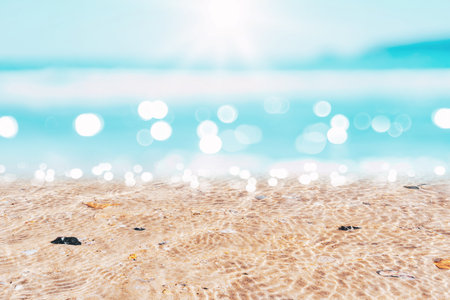 Copy space blur tropical beach with bokeh sun light wave on blue sky and white cloud abstract background. Summer vacation outdoor and travel holiday adventure concept. Vintage tone filter effect color.の写真素材