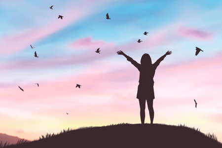 Woman rising hands and birds flying on sunset sky at nature field abstract background. Freedom feel good and travel adventure concept. Vintage tone filter effect color style.の写真素材