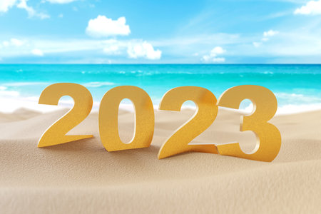 2023 gold number on sand beach with blue sky and white clouds abstract background. Happy new year...