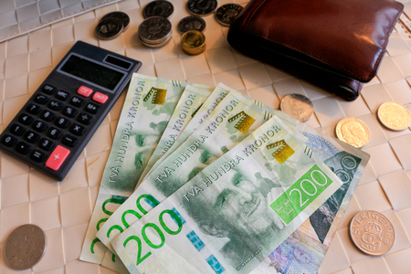 Savings, finances, economy - close up of man counting money; Counting money - Swedish Kronor.
