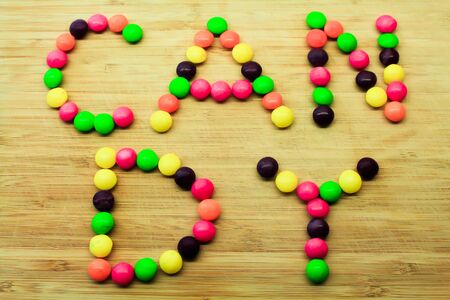 Candy on wood table, with added retro vintage filters and light stream lens flare.の写真素材