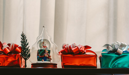 Christmas concept background with decorations and gift boxes and star on wooden boards with copy...