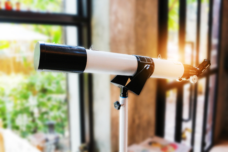 Telescope setting near the window, Orange light.の写真素材