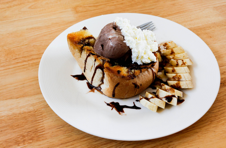 Ice cream honey toast and banana on wood table.の写真素材