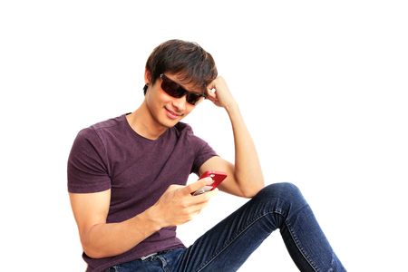 Handsome young man is using smartphone. Him so very happy on a free dayの写真素材