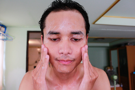 Handsome man happy cleanses the skin.の写真素材