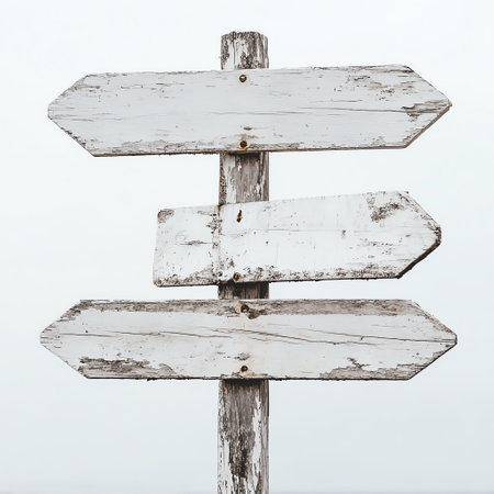 Rustic wooden directional signpost with multiple weathered arrows against a clear sky, symbolizing choice, navigation, and exploration in a natural setting.の素材