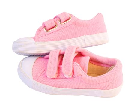 Pink sneakers for a small girl, isolated against backgroundの写真素材