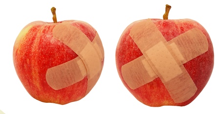 Wounded apples with a plasterの写真素材