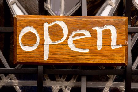Open sign against a fenceの写真素材