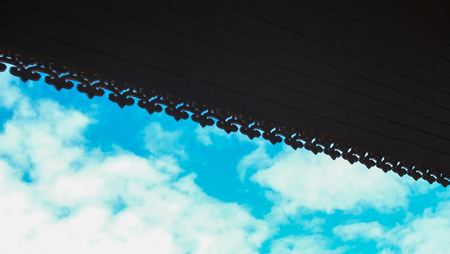 Silhoulette perforated wooden for roof with vivid sky behind