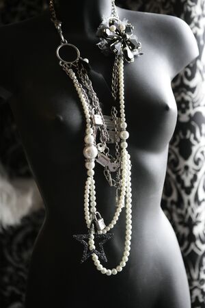 Black mannequin in backlit at natural light wearing nice jewelryの写真素材