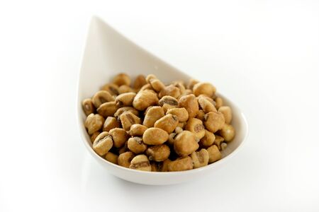 Roastwed salted corn in a white bowl, white background studio shoot