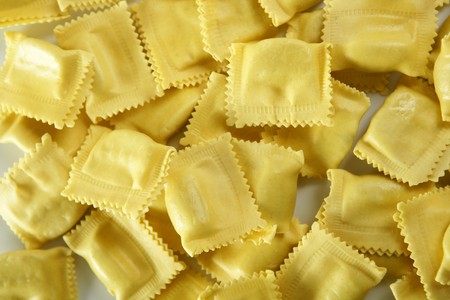 Cheese filled Italian yellow pasta texture, white background