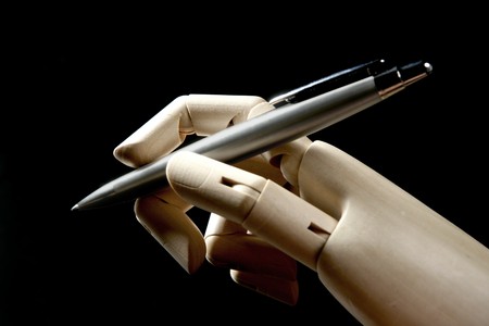 Mannequin wood hand with stainless steel pen to write, signの写真素材
