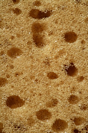 Orange sponge texture background, macro detail of surfaceの写真素材