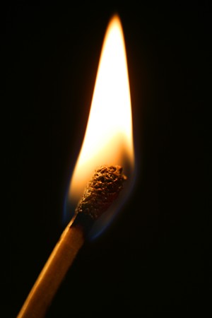 One macro match in flame over black backgroundの写真素材