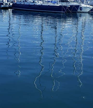 Boats abstract reflexion over blue mediterranean saltwaterの写真素材