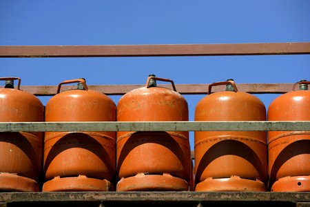 Botellas, bombonas de gas butano color Naranja. Orange Gas Racksの写真素材