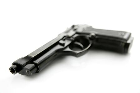 black hand gun pistol over white background, selective focus, studio shotの写真素材