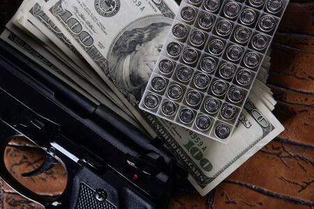Dollar notes and gun, black pistol, mafia inspirationの写真素材
