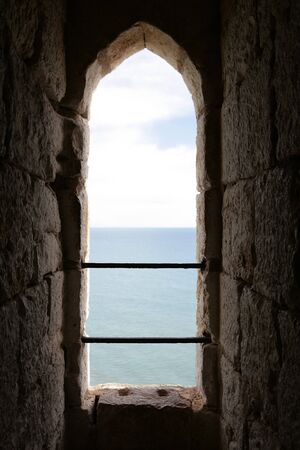 the sea seen through a castle window in Spainの写真素材