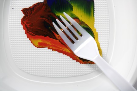 Paint colorful mix with a plastic fork, in white dishの写真素材