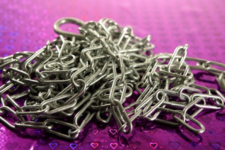 Steel chain mess studio shot over purple background