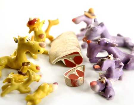 Handmade hungry plasticine dogs withy some meat to eatの写真素材