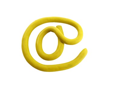 Yellow plasticine arroba email sign, isolated on white bgackgroundの写真素材