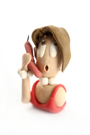 Plasticine handmade woman secretary talking phone isolated on whiteの写真素材