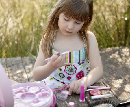 beautiful young girl portrait with make up set outdoors, at the parkの写真素材