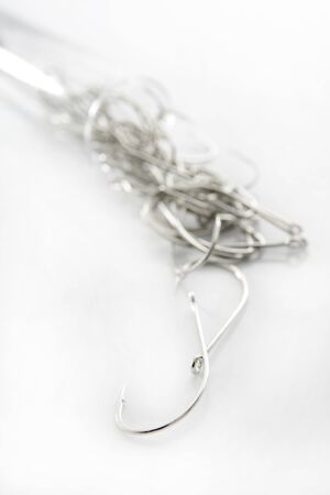 fishing hooks over white background, fisherman equipment