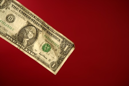 One dollar note over red background, studio crop shotの写真素材
