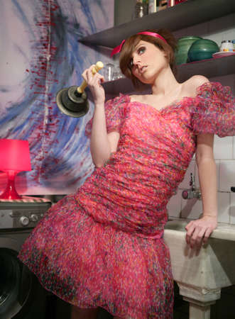 funny young woman housewife, kitchen fashion metaphorの写真素材