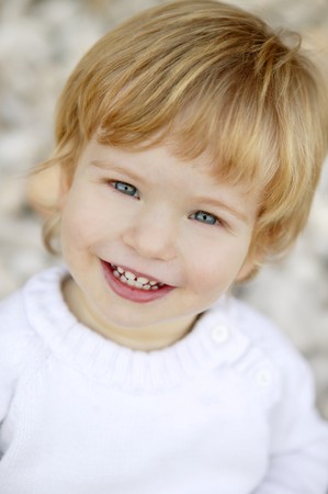 Blond boy smiling portrait on a rolling stones background