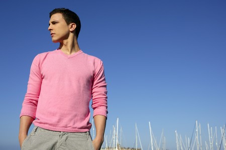 Handsome young man on summer in harbor, blue skyの写真素材