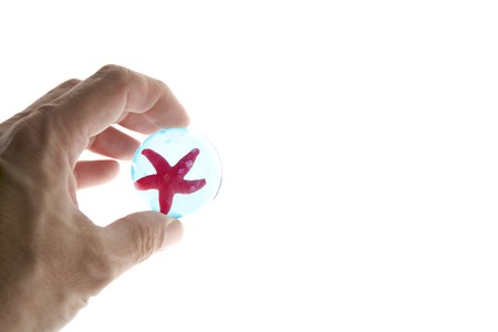 human hand holding starfish, ecology metaphorの写真素材
