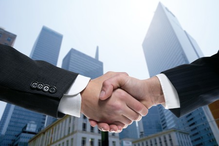 Businessman teamwork partners shaking hands with suit