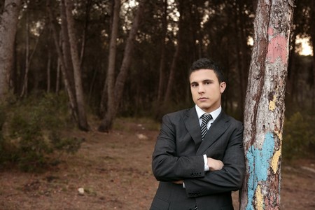 Businessman posing relaxed on a park forest outdoor landscapeの写真素材