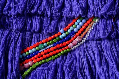 Color stones jewelry necklaces, blue fabric background