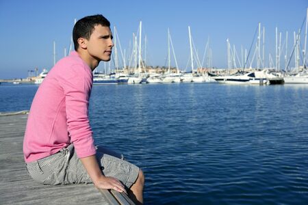 Handsome young man on summer in harbor, blue skyの写真素材