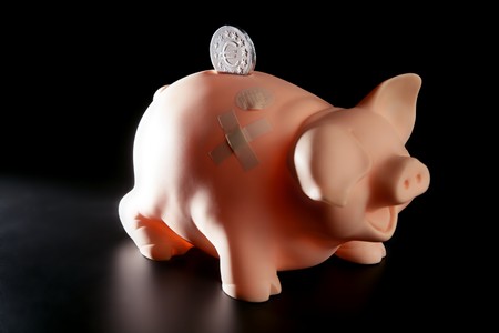 Saving money in crisis time, wounded piggy bankの写真素材
