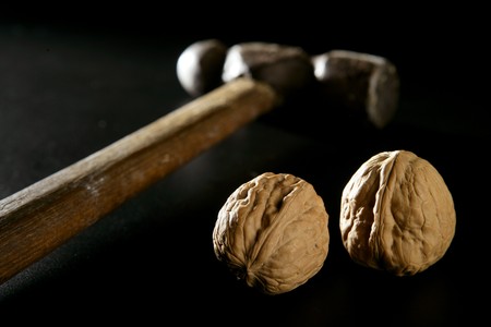 Traditional classic walnut hammer isolated over blackの写真素材
